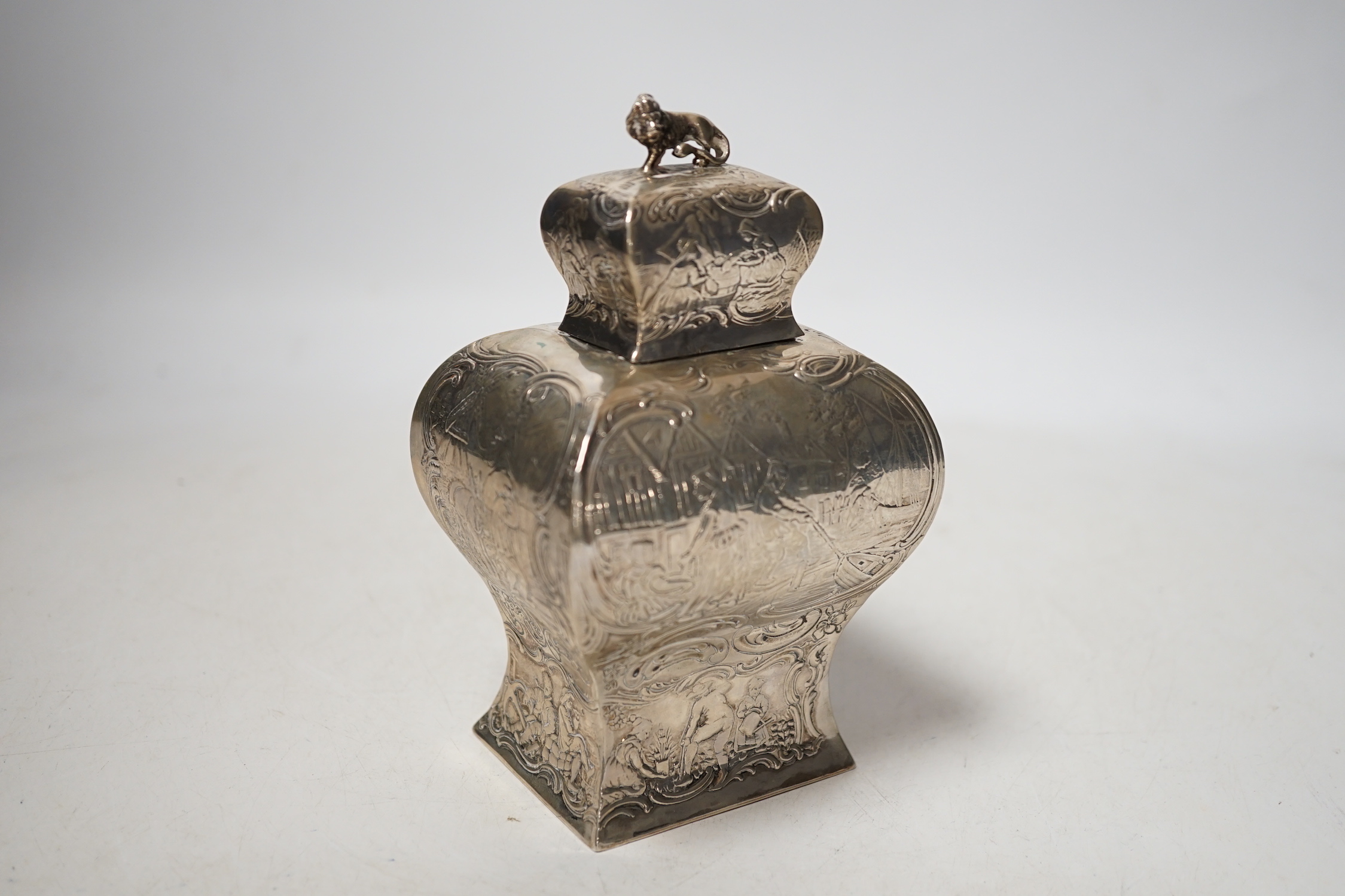 A late 19th century Hanau embossed white metal bombe shaped tea caddy, with lion en passant finial, 13.8cm, 5.5 oz.